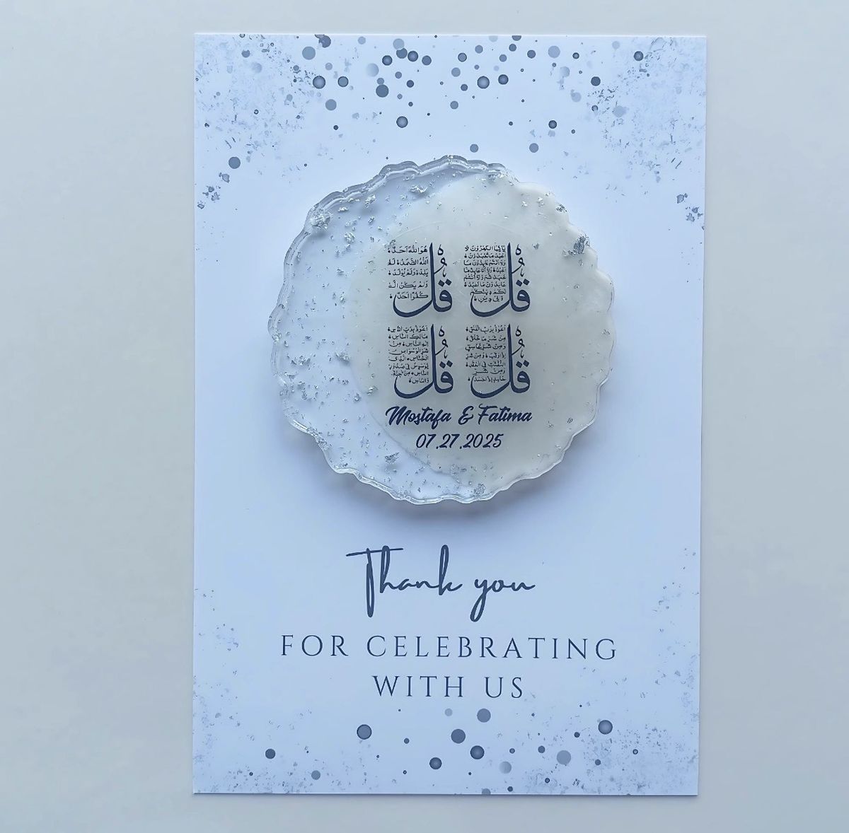 Round resin coaster with the Four Quls, mounted on a pale blue thank-you card for Mostafa & Fatima